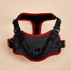 Black padded dog harness with red trim, grab handle and quick-release buckles